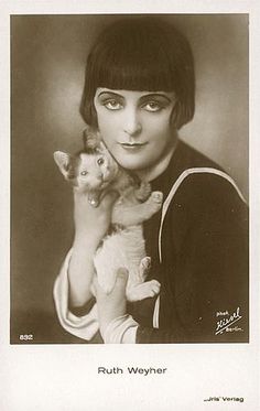 black and white photograph of a woman holding a kitten