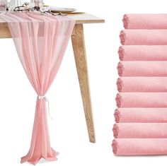 the table is set with pink linens and place settings