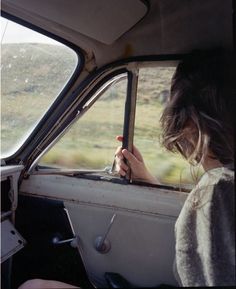 a woman sitting in the passenger seat of a car