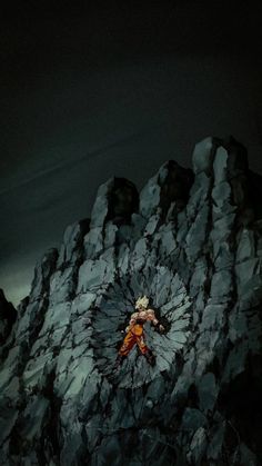 a man climbing up the side of a mountain in front of a dark cloudy sky