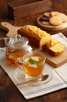 tea and cookies on a wooden table with glass cups, spoons and cutting board