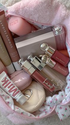 a pink bag filled with lots of different types of cosmetics