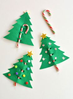 three christmas trees made out of felt with candy canes