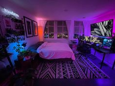 a bed room with a neatly made bed and purple lighting