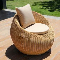 a wicker chair sitting on top of a brick patio