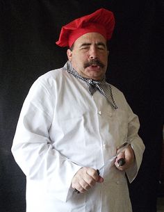 a man in a chef's outfit holding a knife