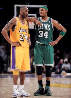 two basketball players standing next to each other