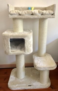 a cat tree with two cats in it