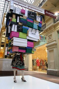 a woman standing in front of a store display