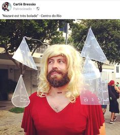 a man with long blonde hair and beard standing in front of some clear plastic pyramids