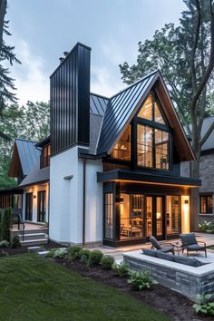 a modern house with an open floor plan and lots of windows on the front porch