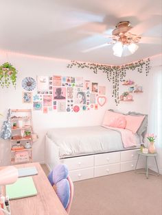 a room with a bed, desk and shelves filled with pictures on the wall next to a window