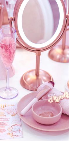 there is a vanity mirror and some pink items on the table