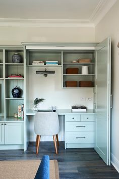 a white desk and some shelves in a room