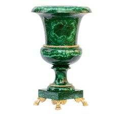 a green vase sitting on top of a wooden stand