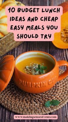 an orange bowl filled with soup on top of a wooden table next to sliced pumpkins