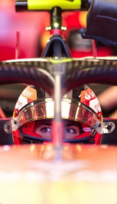 a man in a racing car with his helmet on