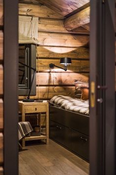 a bedroom with wooden walls and flooring