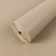 a roll of white fabric sitting on top of a table