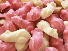 closeup of pink and white candy coated with nuts