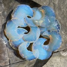 a blue piece of glass sitting on top of a rock