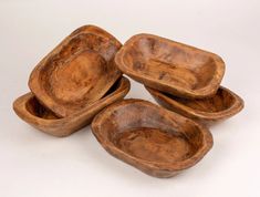 four wooden bowls sitting on top of each other