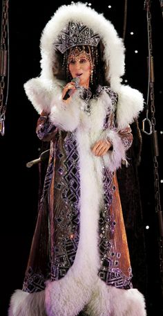 a woman dressed in an elaborate costume on stage