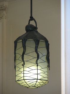 a light hanging from the ceiling in a room