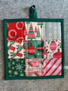 a patchwork christmas ornament hanging on the wall next to a gray carpet