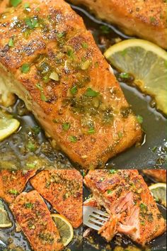 salmon and lemons cooking in a skillet with seasoning on top, then topped with parsley