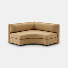 the corner sofa is made out of fabric and has a rounded back, with an open end