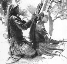 two native american women sitting next to each other