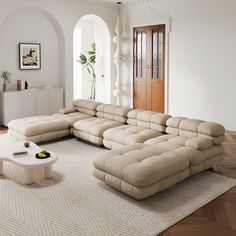 a living room with a large sectional couch in it's center area and a coffee table on the other side