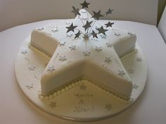 a white cake with silver stars on it