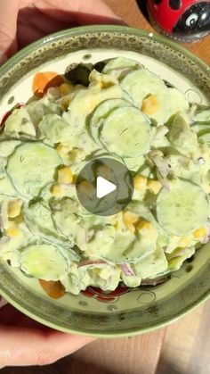 a bowl filled with cucumber and other vegetables