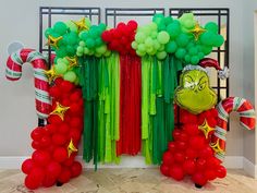 the balloon arch is decorated with green and red balloons