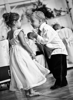 two young children are dancing on the dance floor