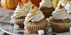 several cupcakes on a plate with marshmallows