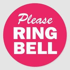 a pink circle with the words please ring bell in white letters on it, against a gray background