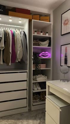 an organized closet with clothes and shoes on the shelves in front of a vanity table