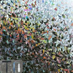 a bathroom with a large mosaic glass wall