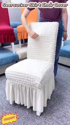 a person kneeling down next to a white chair