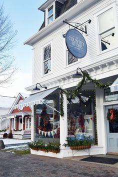 a white building with christmas decorations on the front