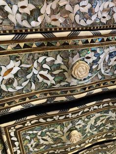 an intricately decorated chest of drawers inlaid with mother of pearl flowers and leaves