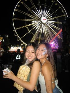 two girls with their faces painted in the theme park