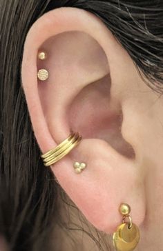 "This clicker hoop is made to create the appearance of three hoops with only one piercing. It fits best worn in a conch piercing in the space where the three hoops can rest toward the bottom of the conch. The hinge is placed for it to fit for the LEFT ear, though if your piercing is in the right ear (as is the case with the model) the hoop can be threaded backwards through the piercing the way a labret post would be threaded. The hinge is attached to the center hoop which is 10mm interior diamet Daith And Conch Earrings, Thick Conch Hoop, Stretched Septum Jewelry, Conch Hoop Jewelry, Coin Slot Piercing, Conch Piercing Hoop, Gold Conch Hoop, Conch Piercing Jewelry, Conch Hoop