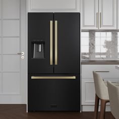 a black refrigerator freezer sitting inside of a kitchen