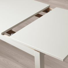 a white table with an open drawer underneath it