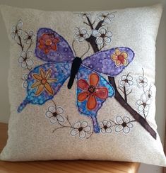 a decorative pillow with a butterfly on it