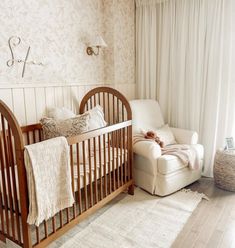 a baby's room with a crib and chair